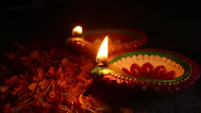 Colorful clay diya or oil lamps lit during Diwali festival. Happy Diwali.