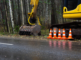 crawler excavator with a bucket for cleaning trees. special equipment for roadside cleaning. repair...