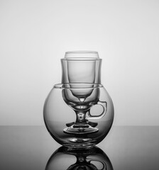 empty drink glasses placed one after another on dark background with back light