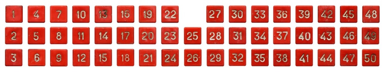 Very old numeric keypad, set of red plastic buttons, numbered from 1 to 50, isolated on white background