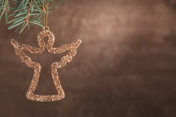 New year or Christmas background in brown with a tree branch and decoration, with space for text.