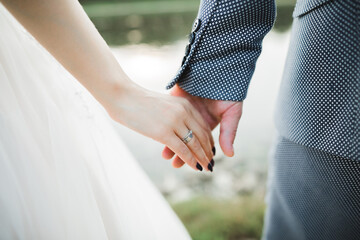 Wedding couple holding hands, groom and bride together on wedding day