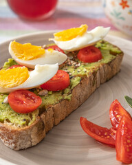 Tostada de aguacate con bol de fruta y zumo de arándanos