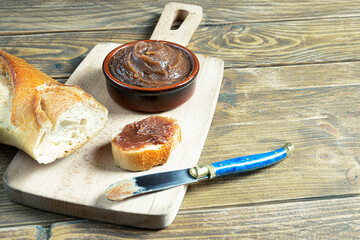 Chestnut cream - traditional French sweet chestnut spread for desserts and baguette on a wooden...