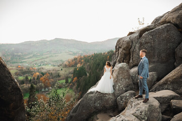 Loving husband and woman on the background of the mountains. Loving couple emotionally spends time