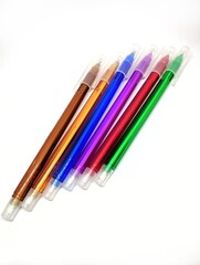 Colorful black ink ball pens on white background-a vertical photo