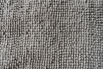 Texture of a gray blanket made of small balls.