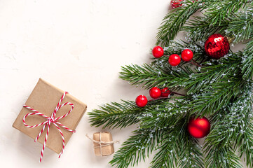 Fir branches with balloons and gifts on a white background.Christmas background with space for text.