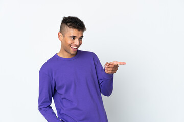 Young brazilian man isolated on white background pointing finger to the side and presenting a product