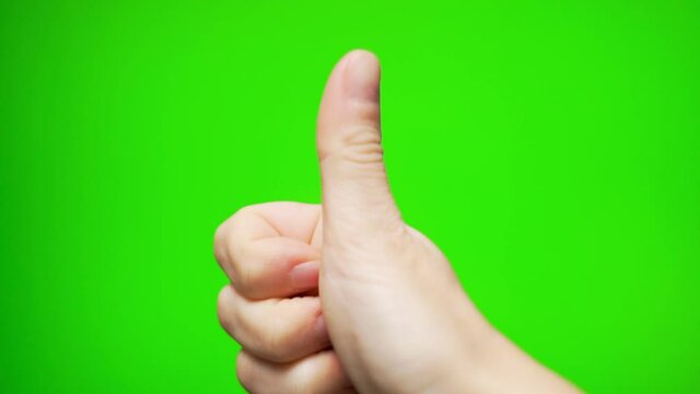 Female Thumbs Up, Gesture Means Everything is COOL OK on a Green Screen, Chromakey, Green Background, Chroma Key Close-up, Macro.
