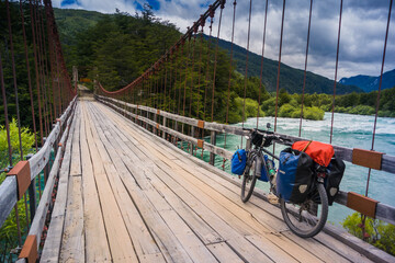 Bicycle crossing an old bridge. Bike tour at Patagonia.