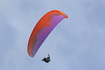 Paraglider flying wing in a blue sky	