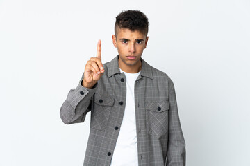 Young brazilian man isolated on white background counting one with serious expression