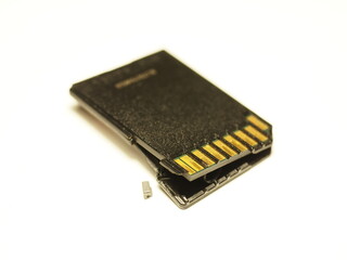 Black SD memory card isolated on white background. Damaged memory card.