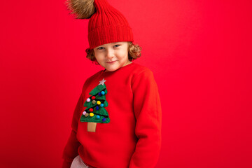 emotional portrait of a teenager on a red background in a new year costume