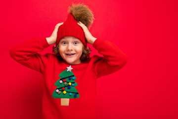 emotional portrait of a teenager on a red background in a new year costume