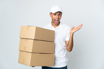 Delivery Brazilian man isolated on white background with shocked facial expression