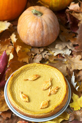 American pumpkin homemade cake, decorated with cookies on a background of pumpkins.