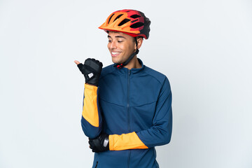 Young cyclist Brazilian man isolated on white background pointing to the side to present a product