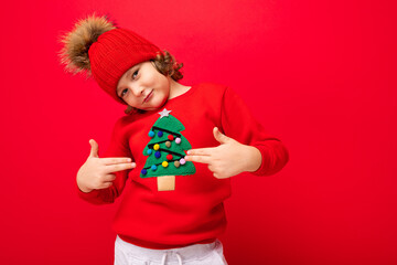 emotional portrait of a teenager on a red background in a new year costume