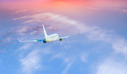 White passenger airplane over the clouds  - Travel by air transport