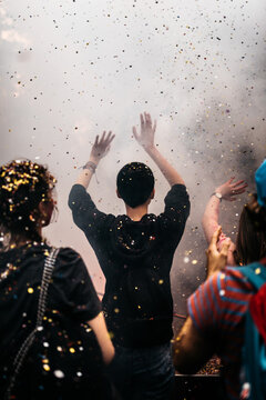 Unrecognizable person dancing in cloud during rave