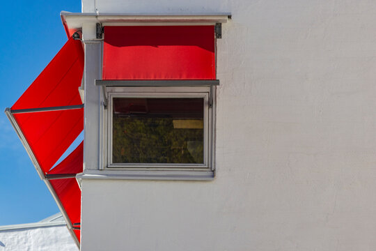 window covered with red canopy