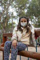 Girl in the park with medical mask