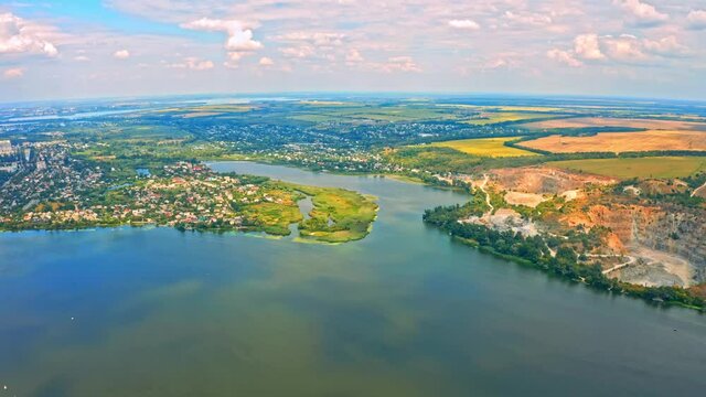 Aerial view over beautiful suburb with a wide river with  privat houses.  Top view over  a  people settlement near water.
