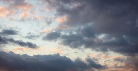 Fototapeta na wymiar Dramatic magical sunrise cloudscape over blue gray color cloudy sky