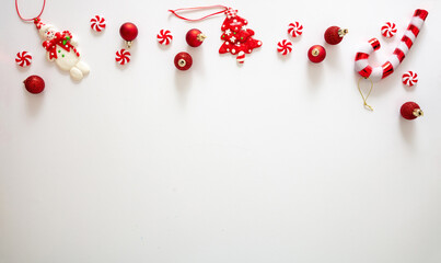 Christmas baubles and candies against white background, xmas ornaments