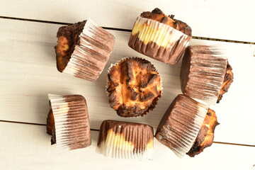 Fragrant chocolate curd muffins, close-up, on a  wooden table.