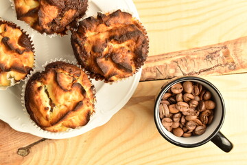 Fragrant chocolate curd muffins, close-up, on a  wooden table.