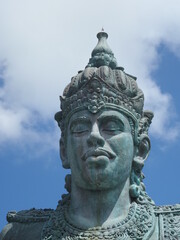 Fototapeta na wymiar giant statue head of Vishnu with blue sky