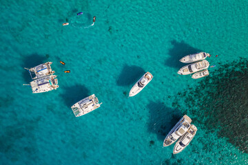 Aerial view of a few boats on the sea. Comino island, Blue lagoon