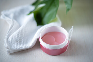 Pink hydrogel eye patches оn a light background. Bathroom treatments. Homemade face care.