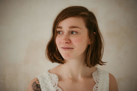 Elegant bride with cute smile in wedding dress