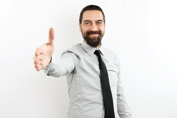 smiling bearded businessman with shirt and tie on white background stretches his arm forward to give handshake in greeting.