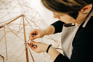 Close Up Of Female Sculptor Working On A Piece Of Metal Sculpture