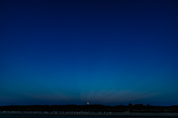 Night sky over dark coast silhouette