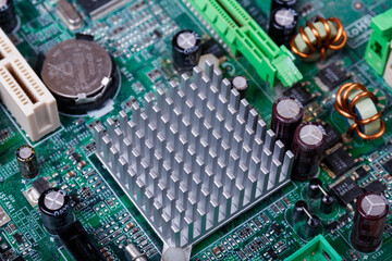 Part of the motherboard of the computer with battery and radiator. Computer circuit board....