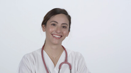 Hispanic medical personnel smiling and laughing against white backdrop.