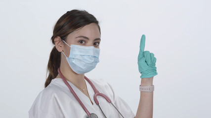 Nurse putting on rubber glove with index finger in the air signaling an exam that is uncomfortable.