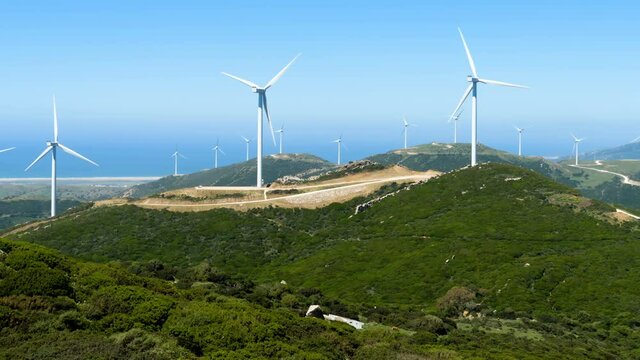 Landscape of wind generators and sea in the background in Tarifa, south of Spain. Nature ecology concept.