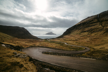 Winding road going amidst mountains on seashore