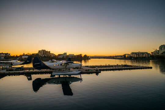 Aircraft near pier during sunset