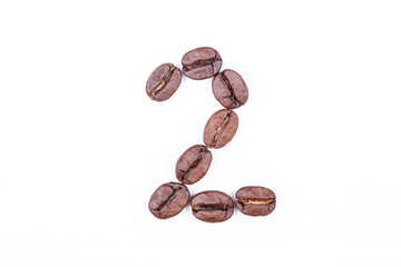 Naklejka premium Number two made of coffee beans on a white background. Coffee beans isolated on white. Macro. 