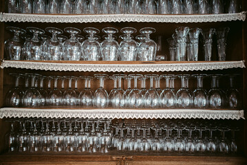 Empty wineglasses on shelves in cabinet