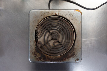 Close up of an old worn single element stove top