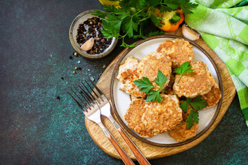Healthy vegan food. Red fish cutlets on a dark stone or slate table. Top view flat lay background. Copy space.